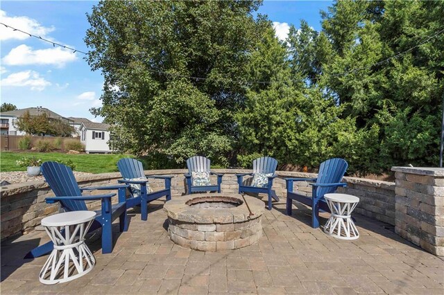 view of patio with an outdoor fire pit and an outdoor structure