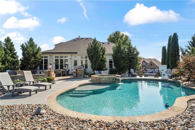 view of swimming pool with a pool with connected hot tub and a patio