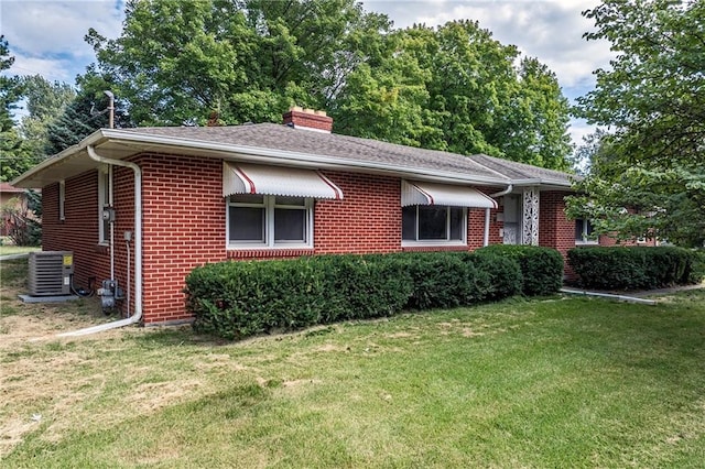 ranch-style house with a front lawn and central AC