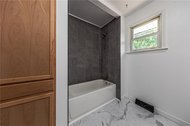 bathroom featuring tiled shower / bath