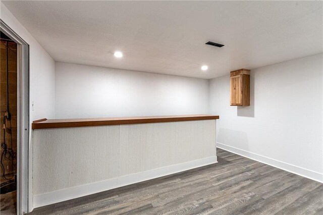 unfurnished room with dark wood-type flooring