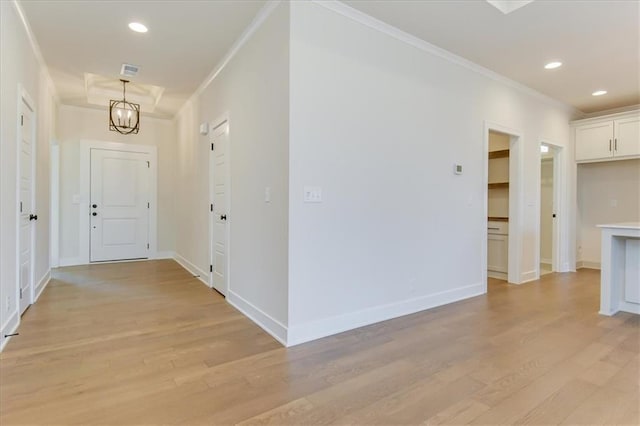 corridor featuring ornamental molding, light wood-style flooring, and recessed lighting