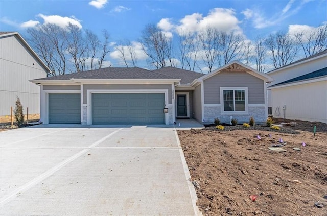 view of front of property featuring a garage, driveway, and stone siding