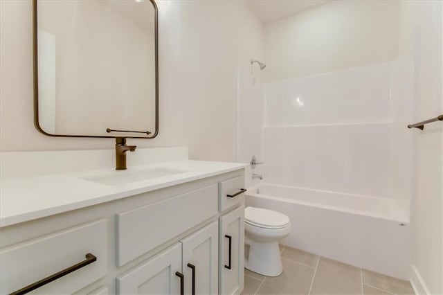 bathroom featuring vanity, tub / shower combination, tile patterned flooring, and toilet