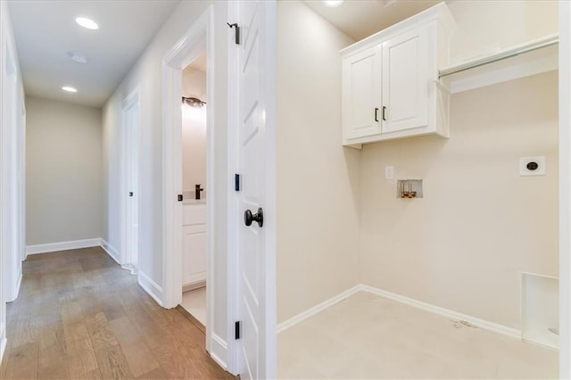 clothes washing area with light wood finished floors, baseboards, hookup for a washing machine, hookup for an electric dryer, and recessed lighting