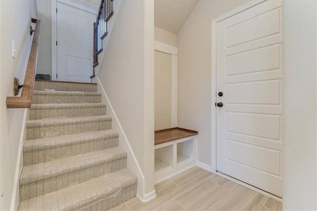 stairway featuring baseboards