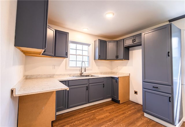 kitchen featuring dark wood-type flooring, sink, and gray cabinetry