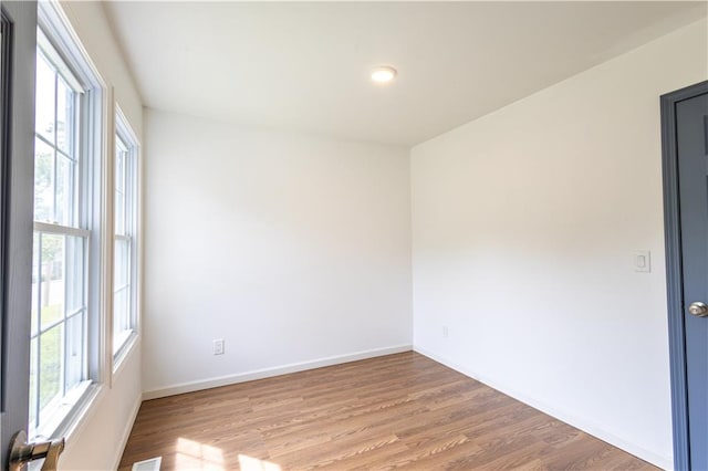 empty room with light hardwood / wood-style floors