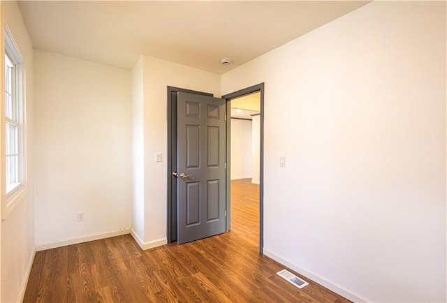 unfurnished bedroom featuring dark hardwood / wood-style floors