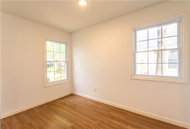 spare room with dark hardwood / wood-style flooring