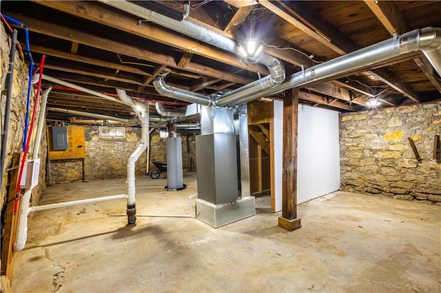 basement featuring gas water heater, electric panel, and heating unit