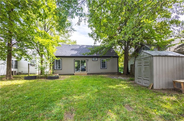 rear view of house featuring a storage unit and a lawn