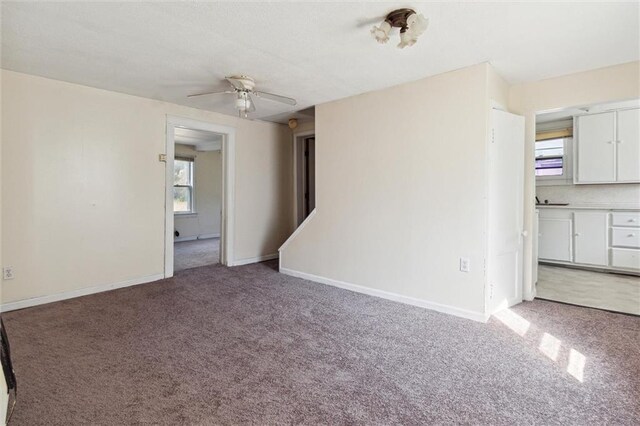 interior space with ceiling fan