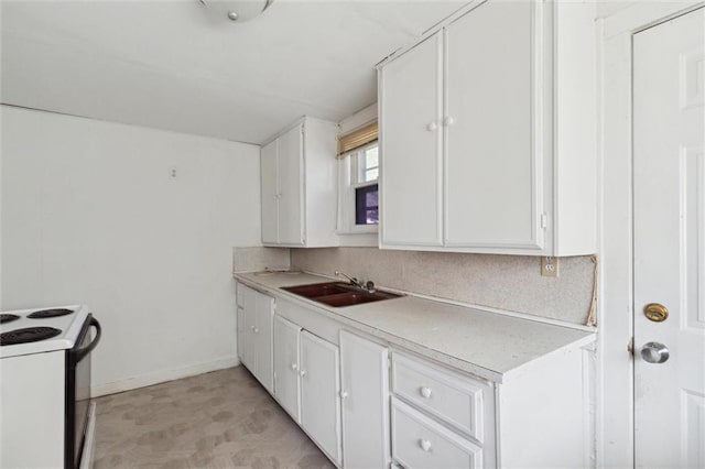 kitchen with white cabinetry, sink, and white electric range