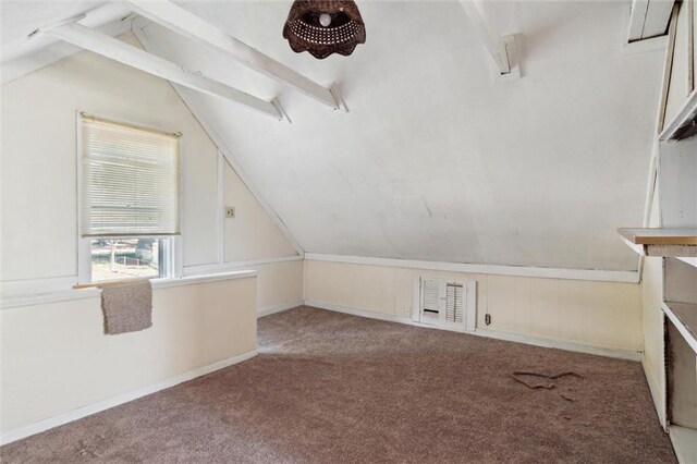 additional living space featuring carpet floors and vaulted ceiling with beams