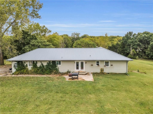 rear view of house featuring a yard and a patio area