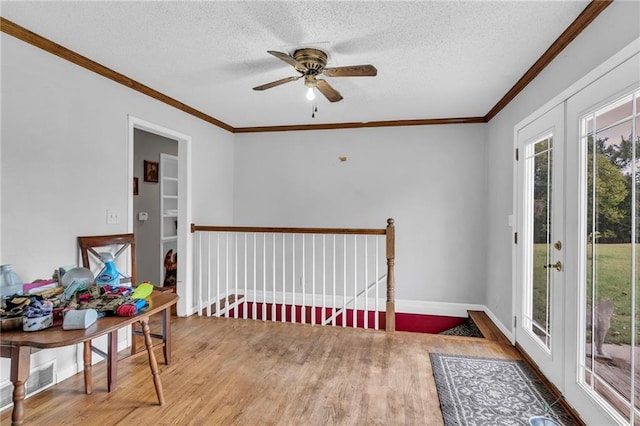 sunroom featuring ceiling fan and french doors