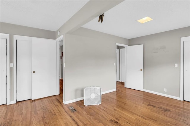 unfurnished bedroom featuring hardwood / wood-style floors