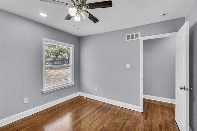 unfurnished room featuring dark hardwood / wood-style floors and ceiling fan