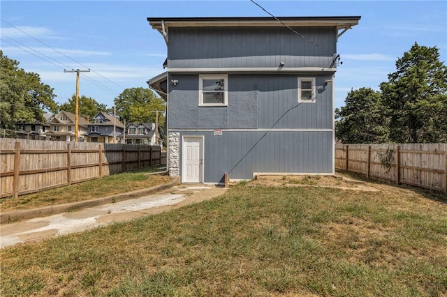 rear view of house with a lawn