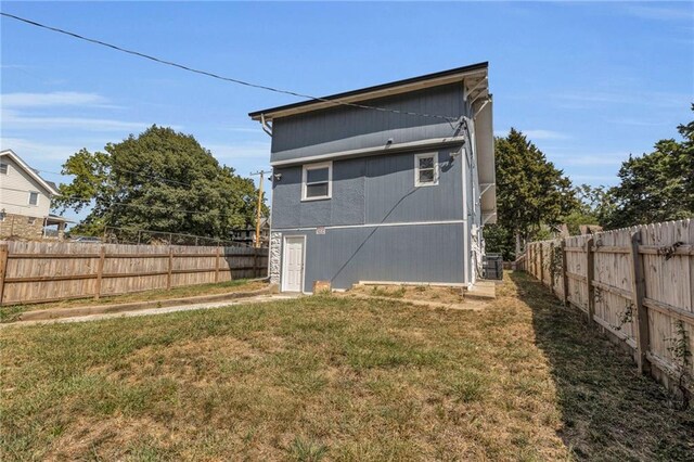 rear view of property with a yard