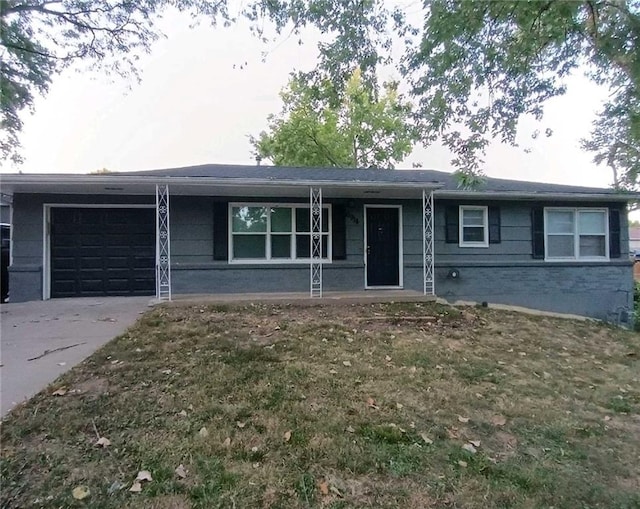 ranch-style house featuring a garage and a front lawn