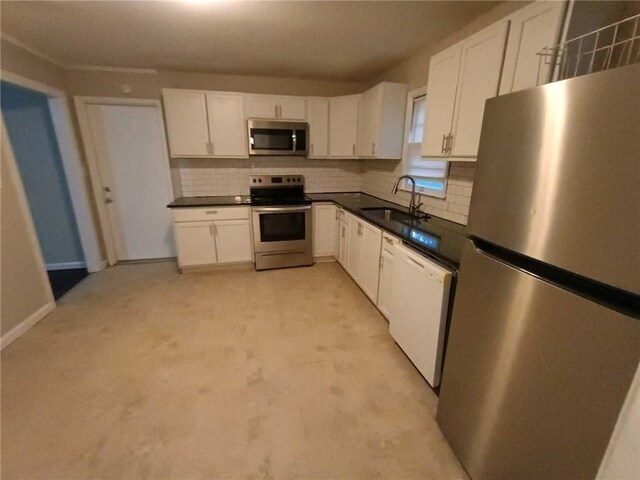 6914 Rowland Ave, Kansas City, KS 66109 - kitchen featuring a sink, dark countertops, white cabinetry, stainless steel appliances, and backsplash
