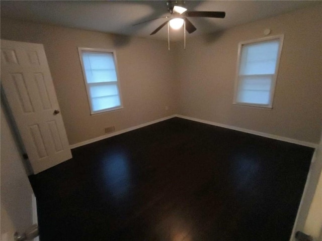 empty room featuring ceiling fan and hardwood / wood-style flooring