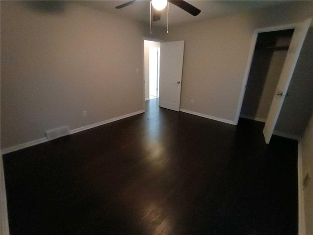 unfurnished room featuring ceiling fan and dark hardwood / wood-style floors