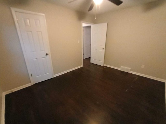 unfurnished bedroom with ceiling fan and dark hardwood / wood-style floors