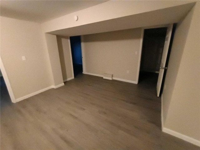 basement featuring dark hardwood / wood-style floors