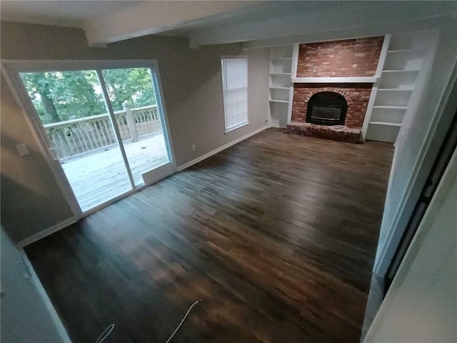 unfurnished living room with beamed ceiling, a fireplace, and dark hardwood / wood-style flooring