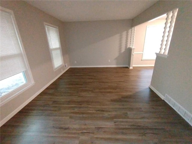 empty room featuring dark wood-type flooring