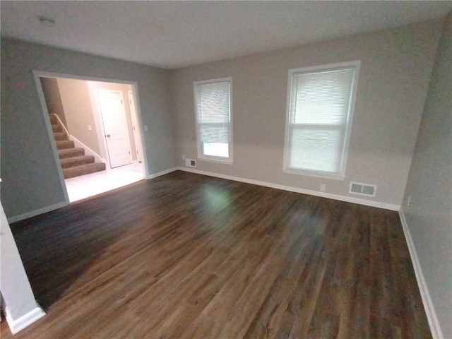 empty room with dark hardwood / wood-style floors