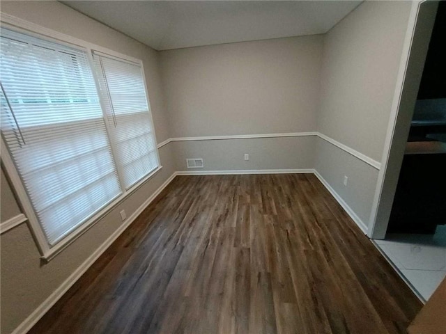 spare room featuring dark wood-type flooring