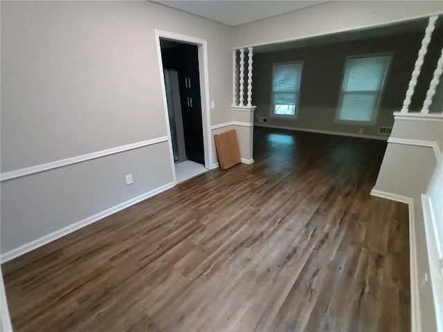 unfurnished living room featuring dark wood-type flooring