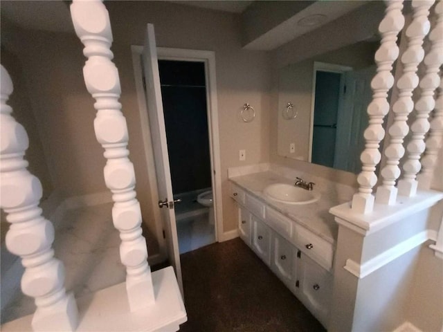 bathroom featuring vanity and toilet