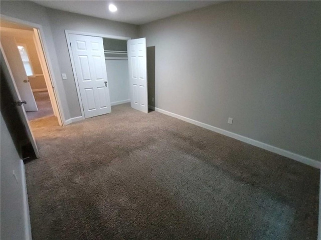 unfurnished bedroom featuring a closet and carpet floors