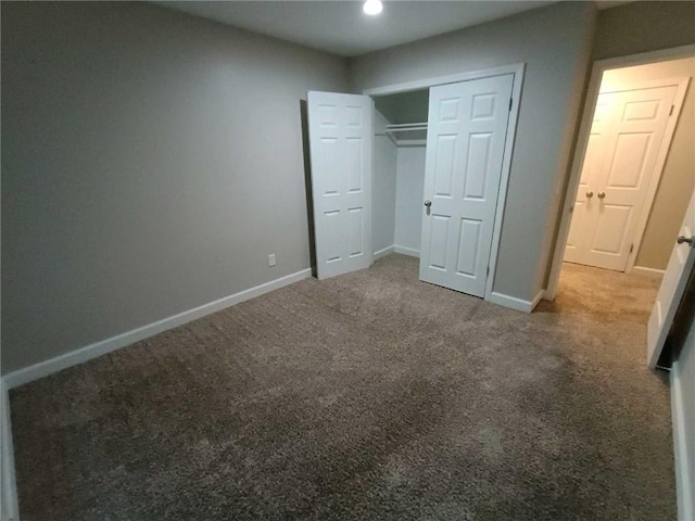 unfurnished bedroom featuring carpet and a closet