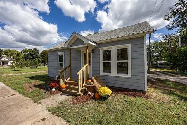 bungalow-style home featuring a front yard