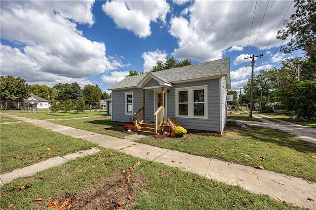 bungalow-style home featuring a front yard