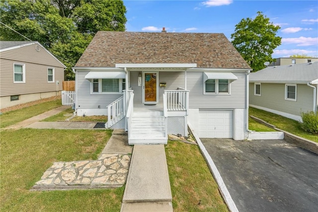 bungalow with a garage and a front lawn