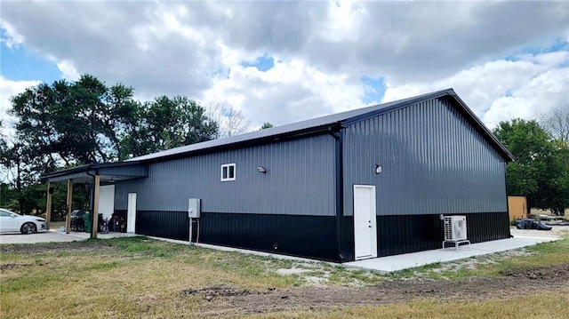 view of home's exterior with cooling unit and a yard