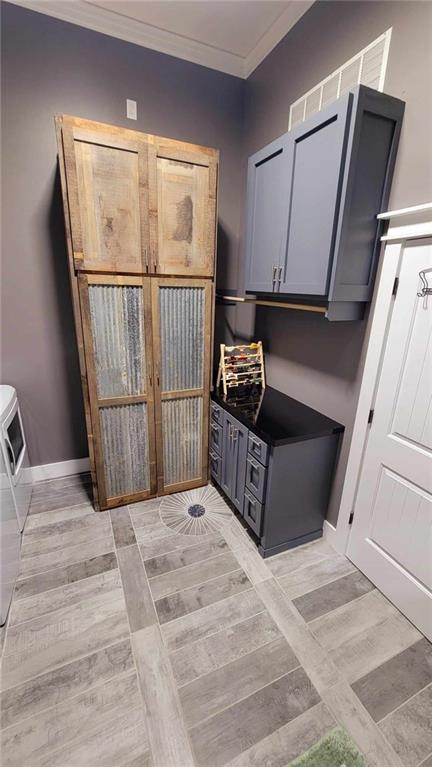 mudroom featuring ornamental molding