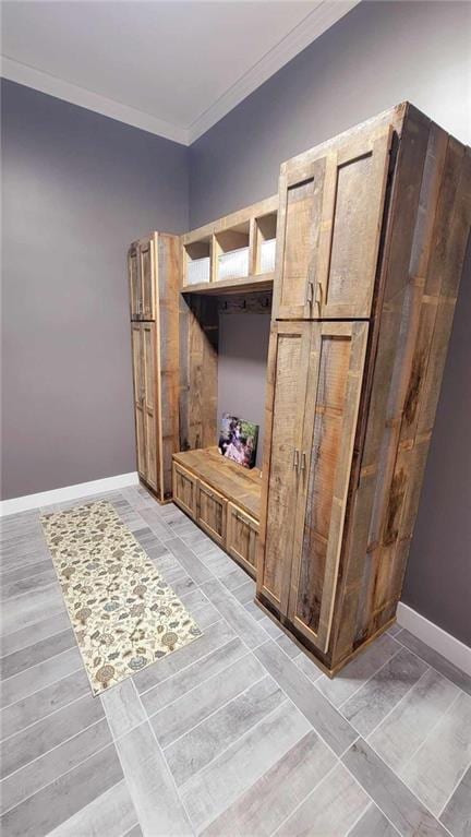 interior space featuring hardwood / wood-style floors and crown molding