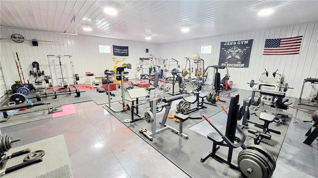 exercise room featuring wood walls