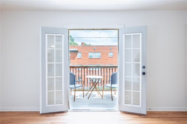 entryway with wood finished floors, baseboards, and french doors