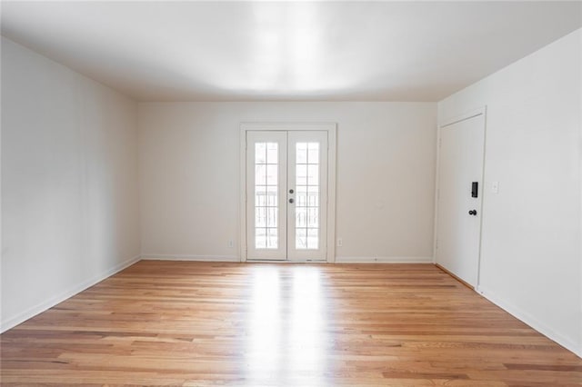 spare room with light wood-style flooring and baseboards