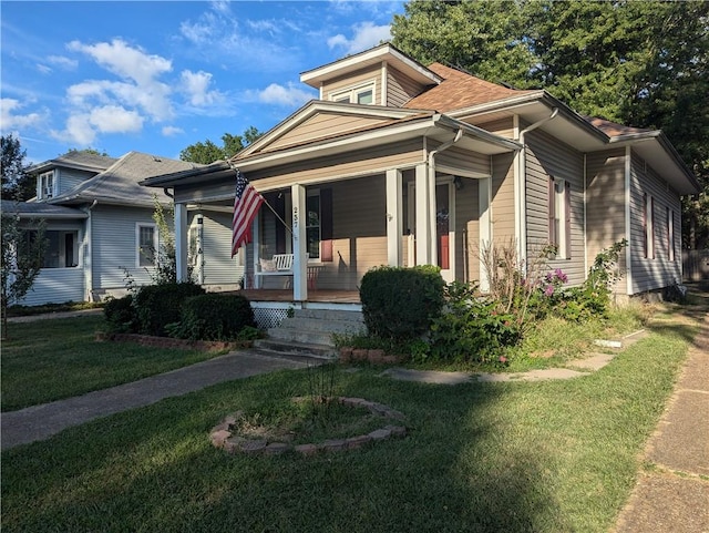 view of front of property featuring a front lawn and covered porch