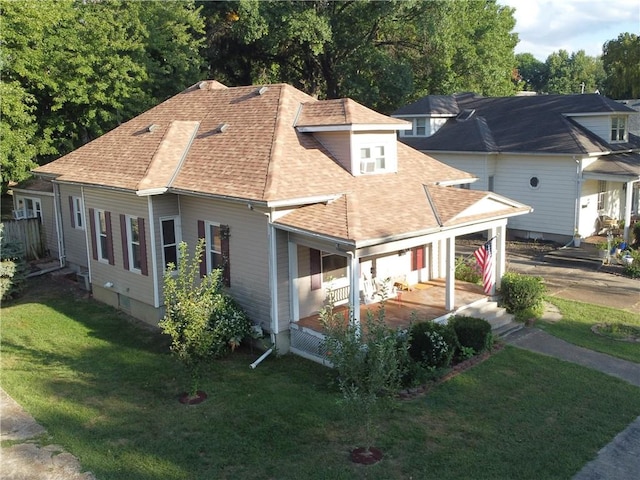 exterior space featuring a lawn and covered porch